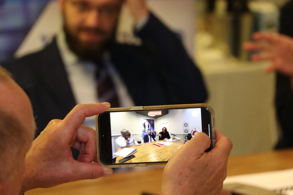 A participant films the discussion on 18 April 2024. A photograph from the report of the same event.